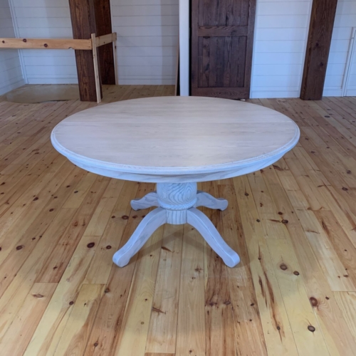 Round pedestal table with whitewash finish